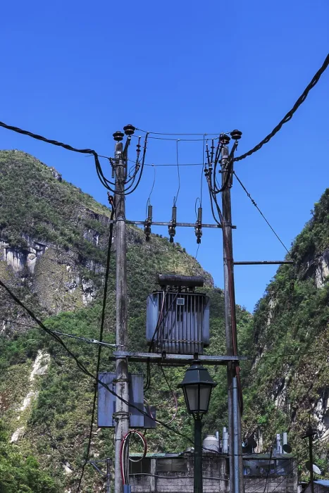 Framed Print : Transformer on a pole on a background of mountains Framed Print : Transformer on a pole on a background of mountains