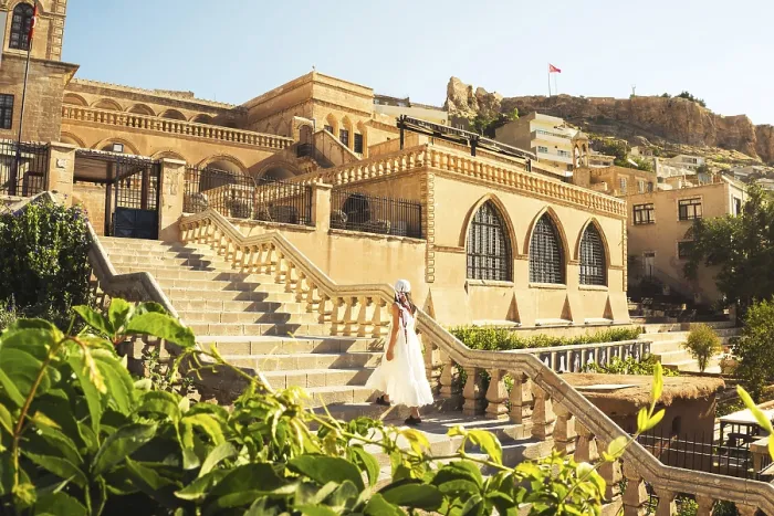 Framed Print : Traveler woman in white dress walking stairs of historic building - visit Mardin museum in old city of Mardin Turkey
