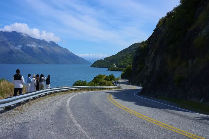 Framed Print : Travellers enjoy the view of the lake and mountains