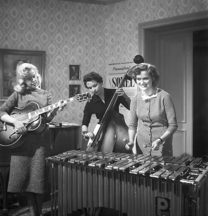 Framed Print : Trio 1956. The photograph, taken in 1956, captures three young women in a band, each immersed in their performance