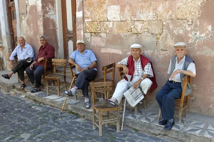Framed Print : Turkish men sitting in front of house
