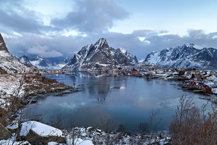 Framed Print : Twilight over a snowy village in Lofoten with calm waters and mountain backdrop Framed Print : Twilight over a snowy village in Lofoten with calm waters and mountain backdrop