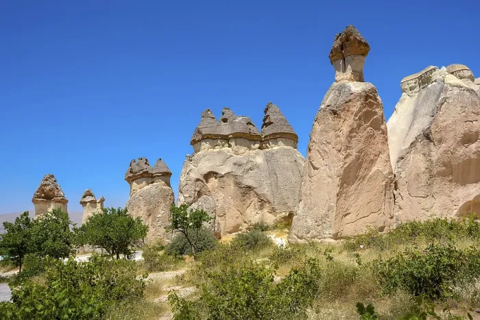Framed Print : Typical and inhabited rock formations in the Cappadocia region of Turkey with blue sky and vegetation
