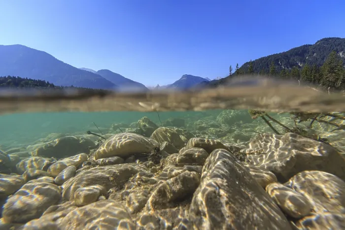 Framed Print : Underwater shot of river in front of mountains