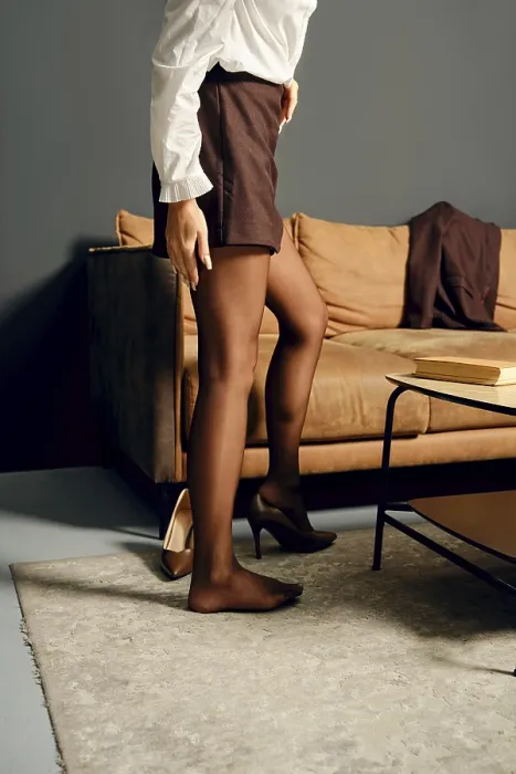Framed Print : Unrecognizable woman put on high heels in a modern living room Framed Print : Unrecognizable woman put on high heels in a modern living room