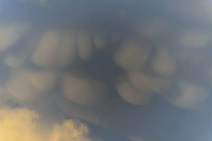 Framed Print : Unusual cloud structures create captivating shapes against a backdrop of warm colours as the sun sets Framed Print : Unusual cloud structures create captivating shapes against a backdrop of warm colours as the sun sets