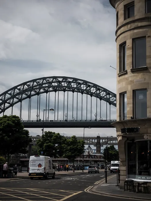 Framed Print : An urban scene with an arch bridge over a road