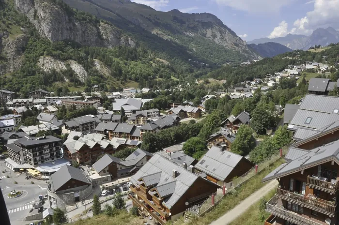Framed Print : Valoire, A scenic village nestled in a mountainous valley with houses and lush greenery