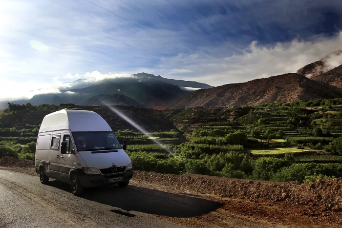 Framed Print : A van on a road with breathtaking views of the green fields of the mountains Framed Print : A van on a road with breathtaking views of the green fields of the mountains