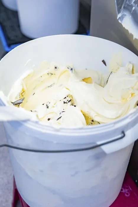 Framed Print : Vanilla ice cream with chocolate chips is stored in a white bucket