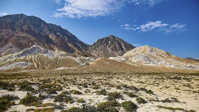 Framed Print : Vast desert-like landscape with volcanic rock and mountain range under a clear sky