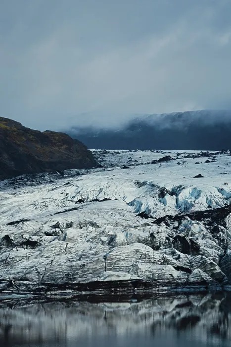 Framed Print : Vast glacier with rugged ice formations beneath a cloudy sky