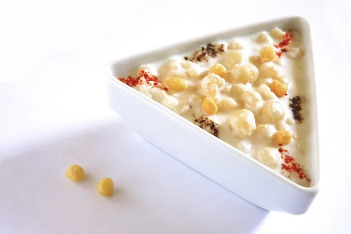 Framed Print : Vegetable salad, boondi raita spiced with chilli powder in triangle plate on white background