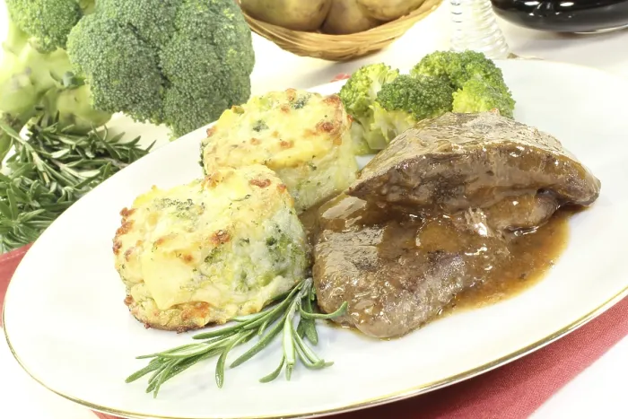 Framed Print : Venison medallions with potato gratin and broccoli against a light background Framed Print : Venison medallions with potato gratin and broccoli against a light background
