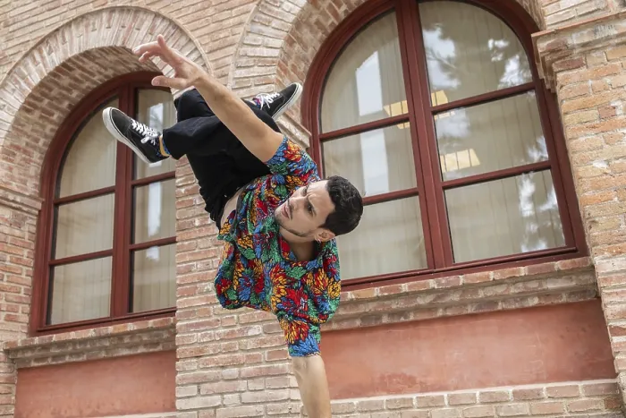 Framed Print : A vibrant Cuban dancer executes an impressive move against a historic brick backdrop Framed Print : A vibrant Cuban dancer executes an impressive move against a historic brick backdrop