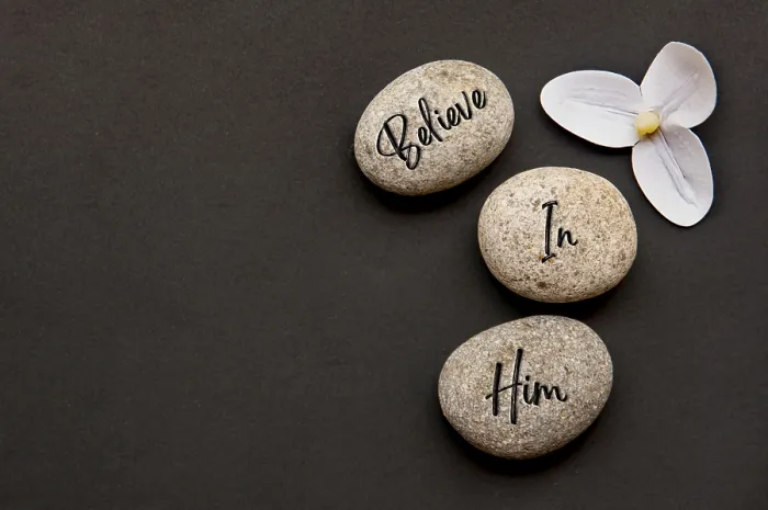 Framed Print : Top view of Believe In Him text engraved on zen stones with additional customizable space for text or messages Framed Print : Top view of Believe In Him text engraved on zen stones with additional customizable space for text or messages