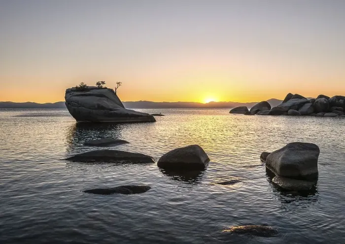 Framed Print : View of Bonsai Rock, small tree on a rock in the water at sunset