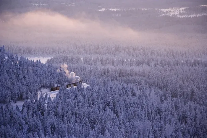 Framed Print : View from the Brocken mountain over a winter landscape deeply covered in snow at sunset and the Harzer Schmalspurbahn