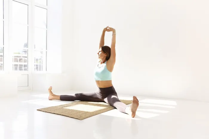 Framed Print : Side view of calm female in sportswear practicing yoga in Firefly pose while balancing on arms on mat and looking away