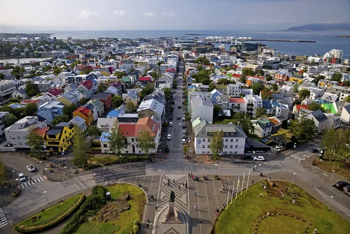 Framed Print : View of the colourful rooftops of Reykjavik and the sea from Hallgrims Church with the monument to Leif Erikson