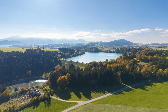 Framed Print : View of Forggensee surrounded by trees and mountains under clear sky Framed Print : View of Forggensee surrounded by trees and mountains under clear sky