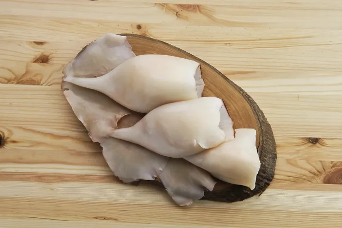 Framed Print : Top view of frozen pilled squid on wooden table
