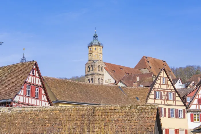 Framed Print : View of half-timbered houses and a tower rising above tiled roofs