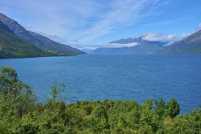 Framed Print : View of a lake framed by mountains and a blue sky