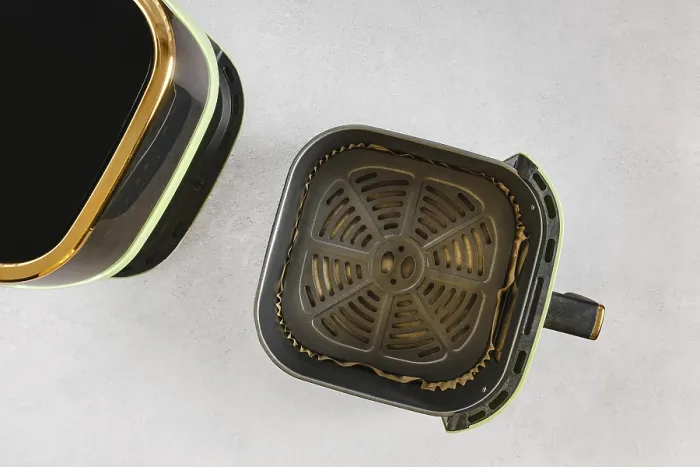 Framed Print : Top view of modern air fryer with empty basket lined with parchment paper Framed Print : Top view of modern air fryer with empty basket lined with parchment paper