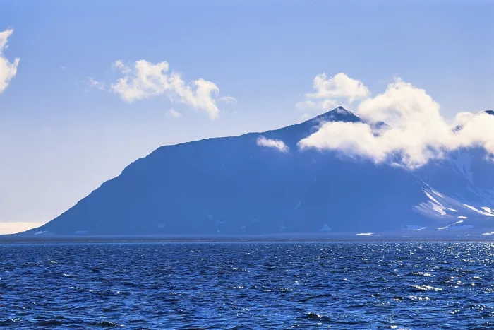 Framed Print : View at a mountain with clouds at Svalbard coast
