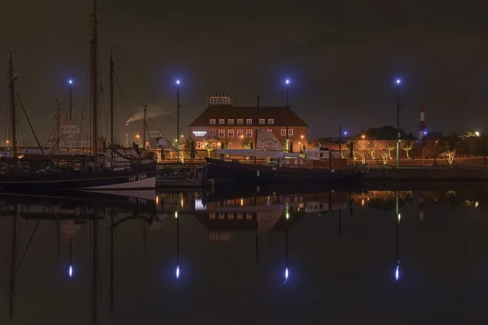 Framed Print : View over the new harbour to a restaurant in Bremerhaven at night Framed Print : View over the new harbour to a restaurant in Bremerhaven at night