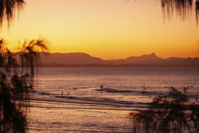 Framed Print : View of the ocean and Wategos Beach on the promenade at sunset