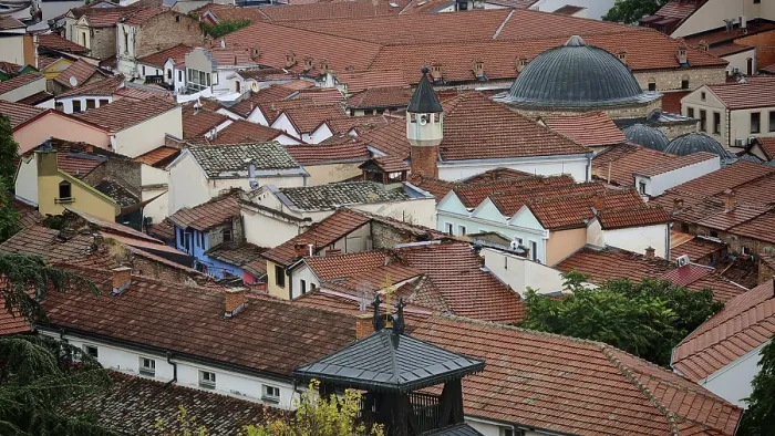 Framed Print : View of an old town with red tiled roofs and a dome