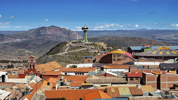 Framed Print : View of orange roofs with a modern building and an antenna in a mountainous environment