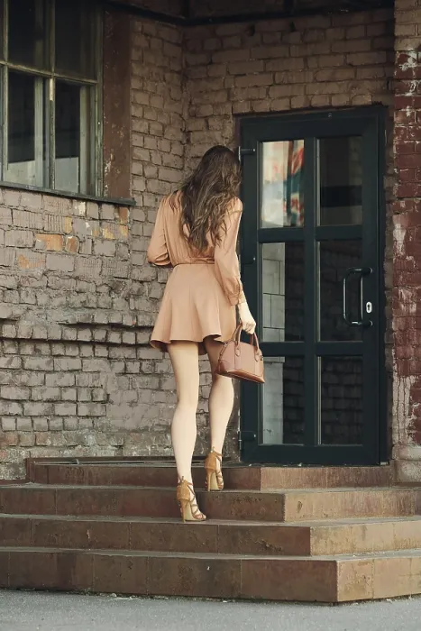 Framed Print : Back view of pretty young woman climbing the stairs of old building