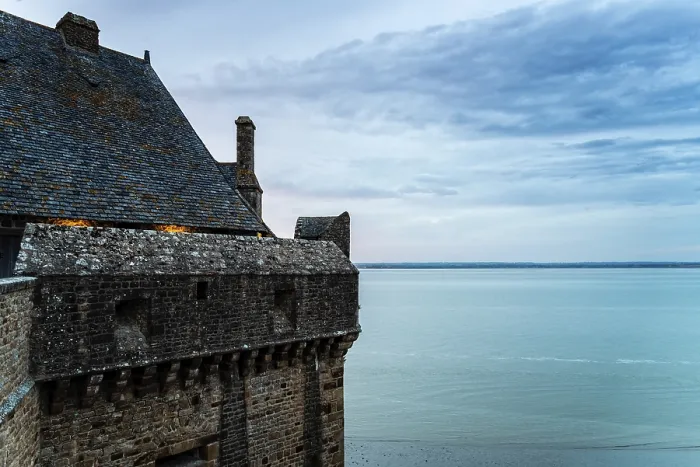 Framed Print : View of the ramparts of Mont Saint Michel with the tide coming in at sunset
