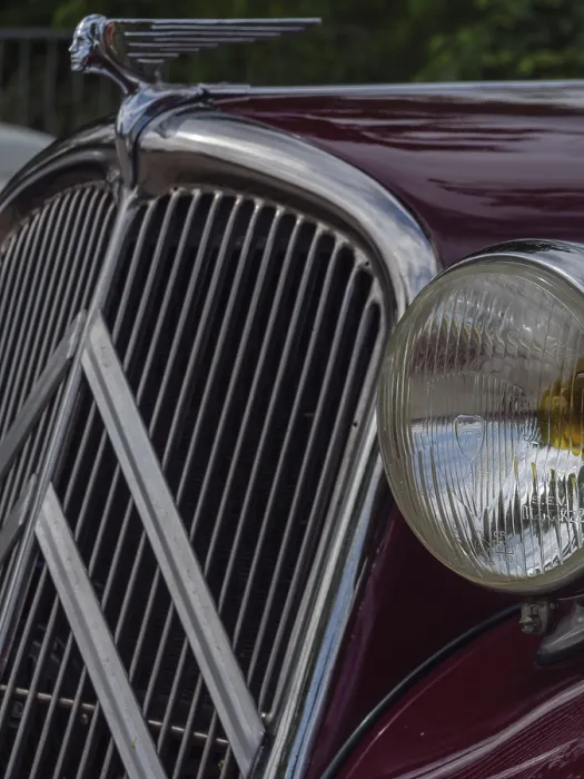 Framed Print : Front view of a red vintage car with striking radiator grille and detailed emblem