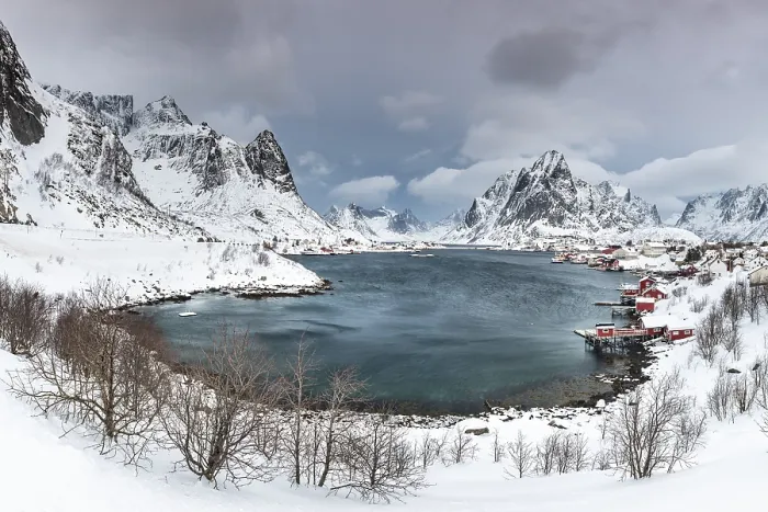 Framed Print : View of Reine with Reinefjord, snow-covered mountains at the back