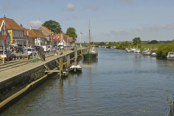 Framed Print : View of river, boats and quay in historic town