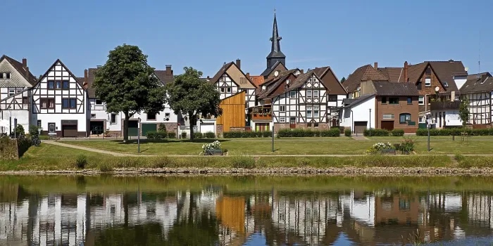 Framed Print : View over the river Weser to the old town centre of Bodenwerder with the church tower of St