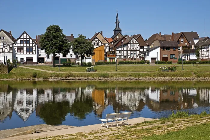 Framed Print : View over the river Weser to the old town centre of Bodenwerder with the church tower of St