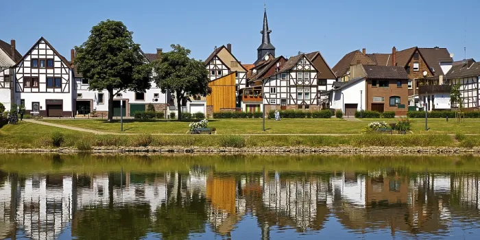 Framed Print : View over the river Weser to the old town centre of Bodenwerder with the church tower of St
