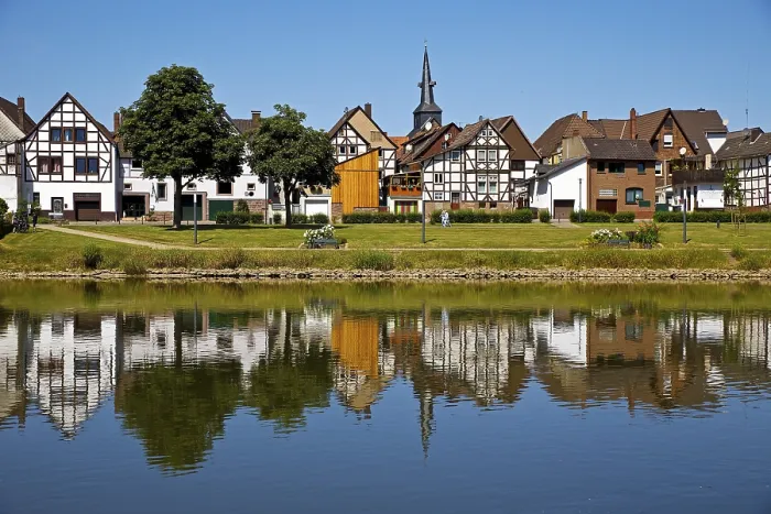 Framed Print : View over the river Weser to the old town centre of Bodenwerder with the church tower of St