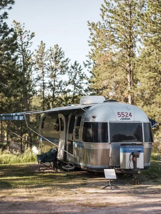 Framed Print : Front view of a silver Airstream camper in a forested area Framed Print : Front view of a silver Airstream camper in a forested area