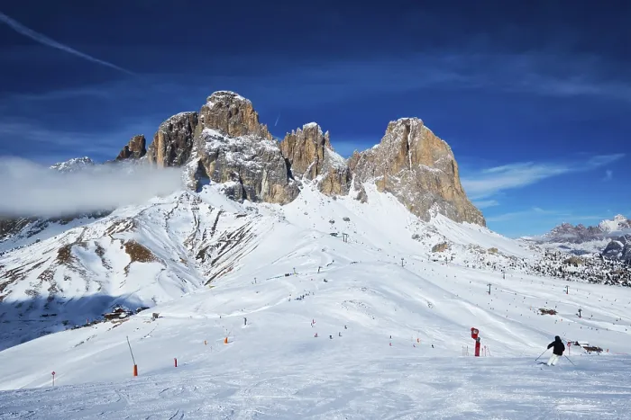 Framed Print : View of a ski resort piste with people skiing in Dolomites in Italy