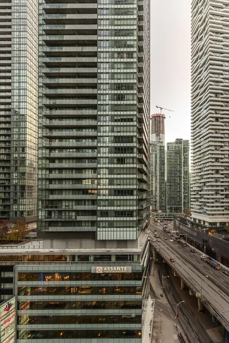 Framed Print : View of tall skyscrapers flanking a busy urban roadway amidst a densely built-up environment in Toronto