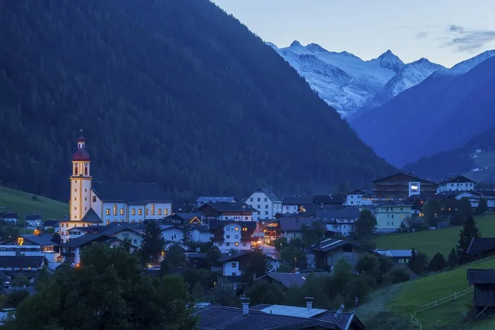 Framed Print : View of town with mountains and Stubai glacier at dusk