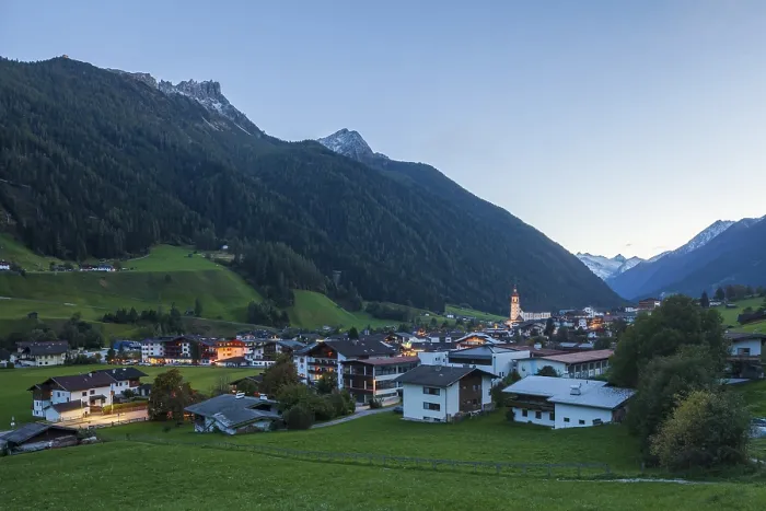 Framed Print : View of town with mountains and Stubai glacier at dusk