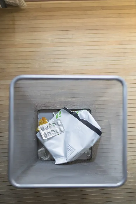 Framed Print : A top down view of a trash bin containing used pill packaging and other waste Framed Print : A top down view of a trash bin containing used pill packaging and other waste