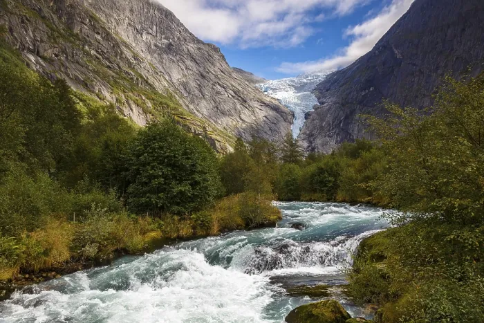 Framed Print : View across a travelling river to the Briksdalsbreen glacier in Norway